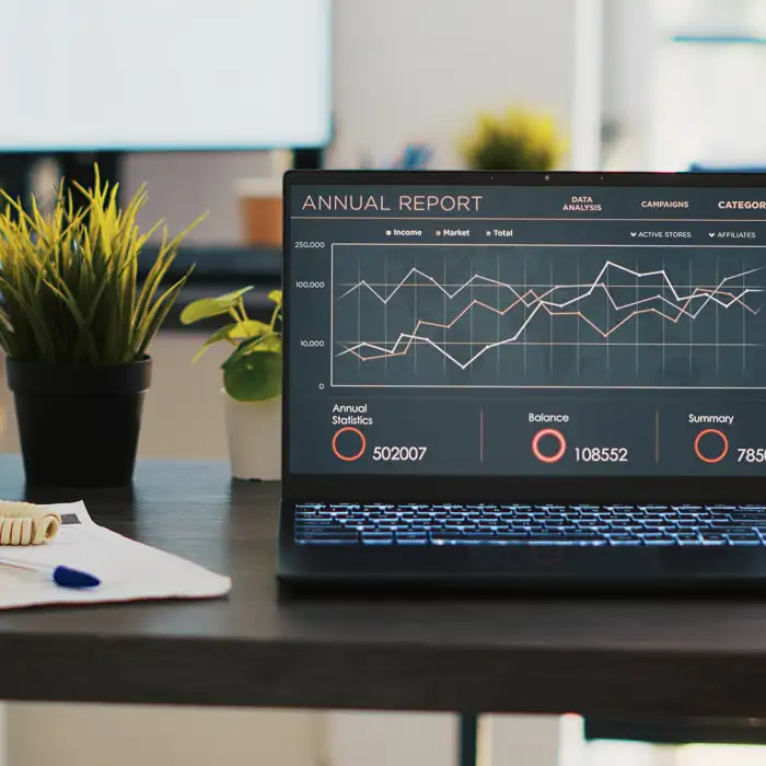 business-graphs-figures-laptop-left-open-desk-empty-office.jpg